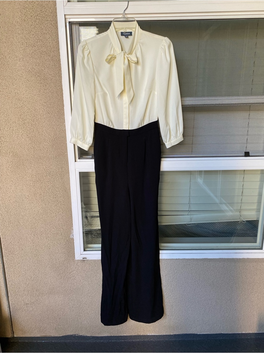 This garment is the ModCloth Pretty Polished Twofer Jumpsuit Cream Bow Blouse wi